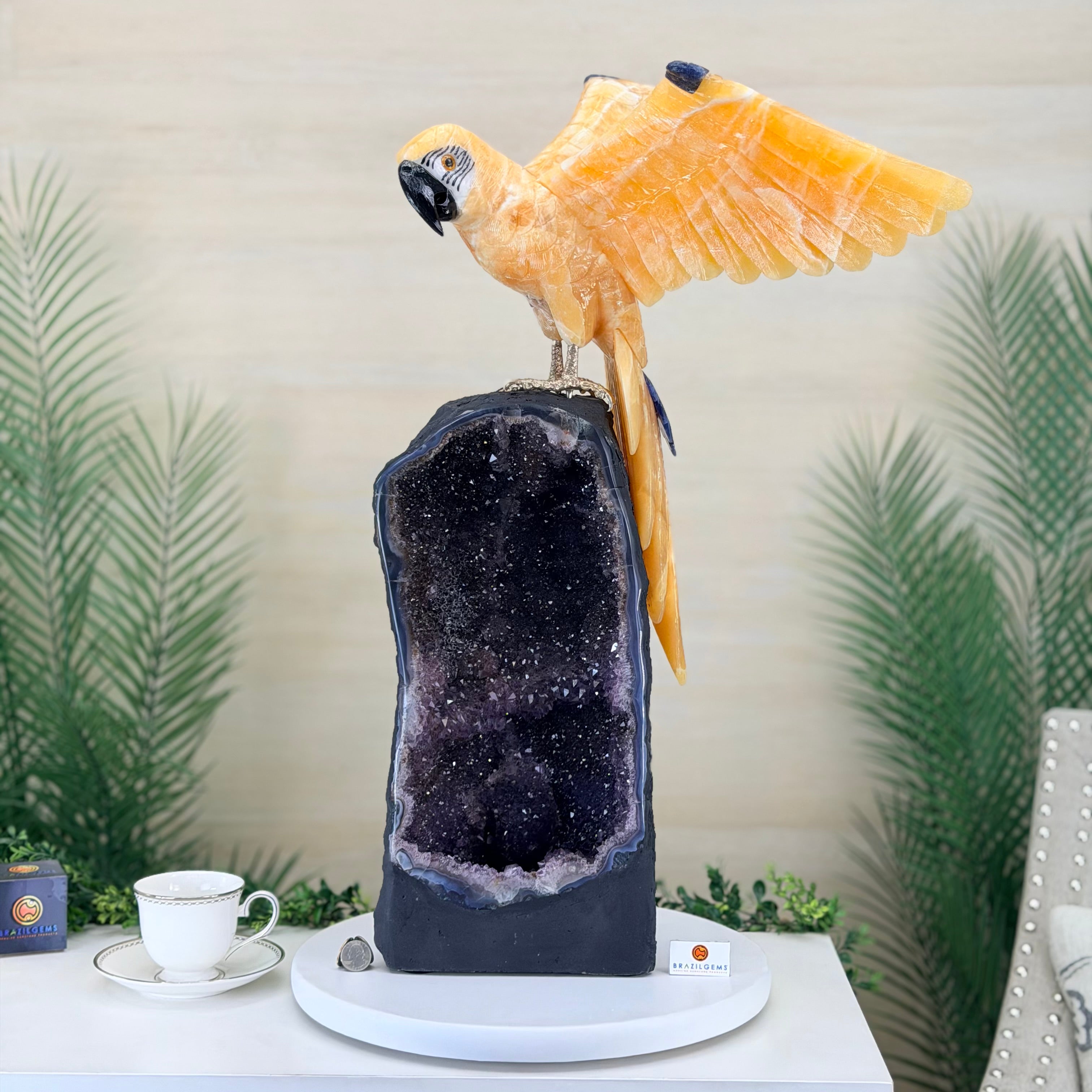 Decorative piece with a parrot on a geode-like structure against a neutral background