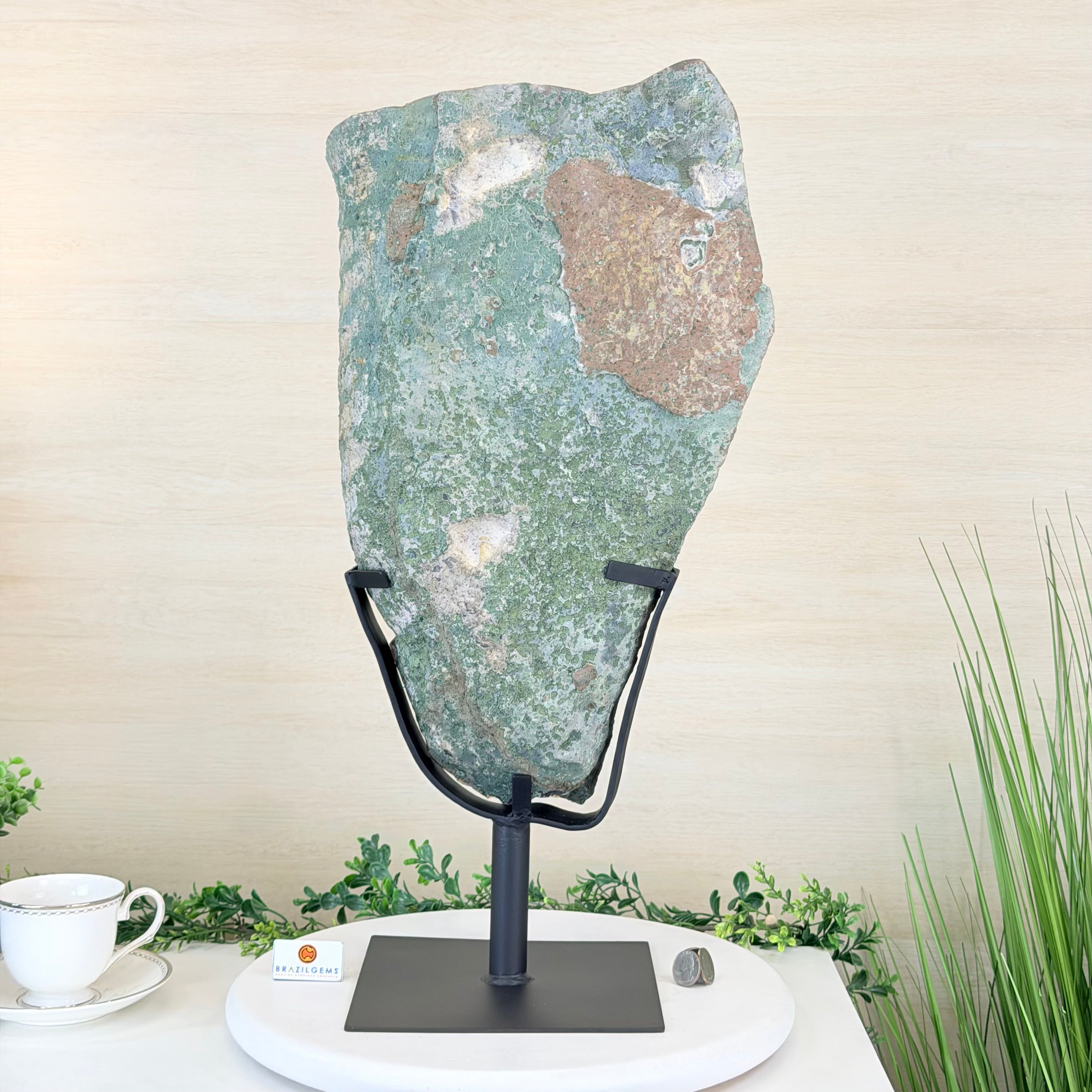 Decorative stone on a stand with a cup and saucer in the background