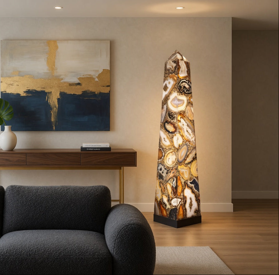 Decorative obelisk in a living room with a painting and console table.