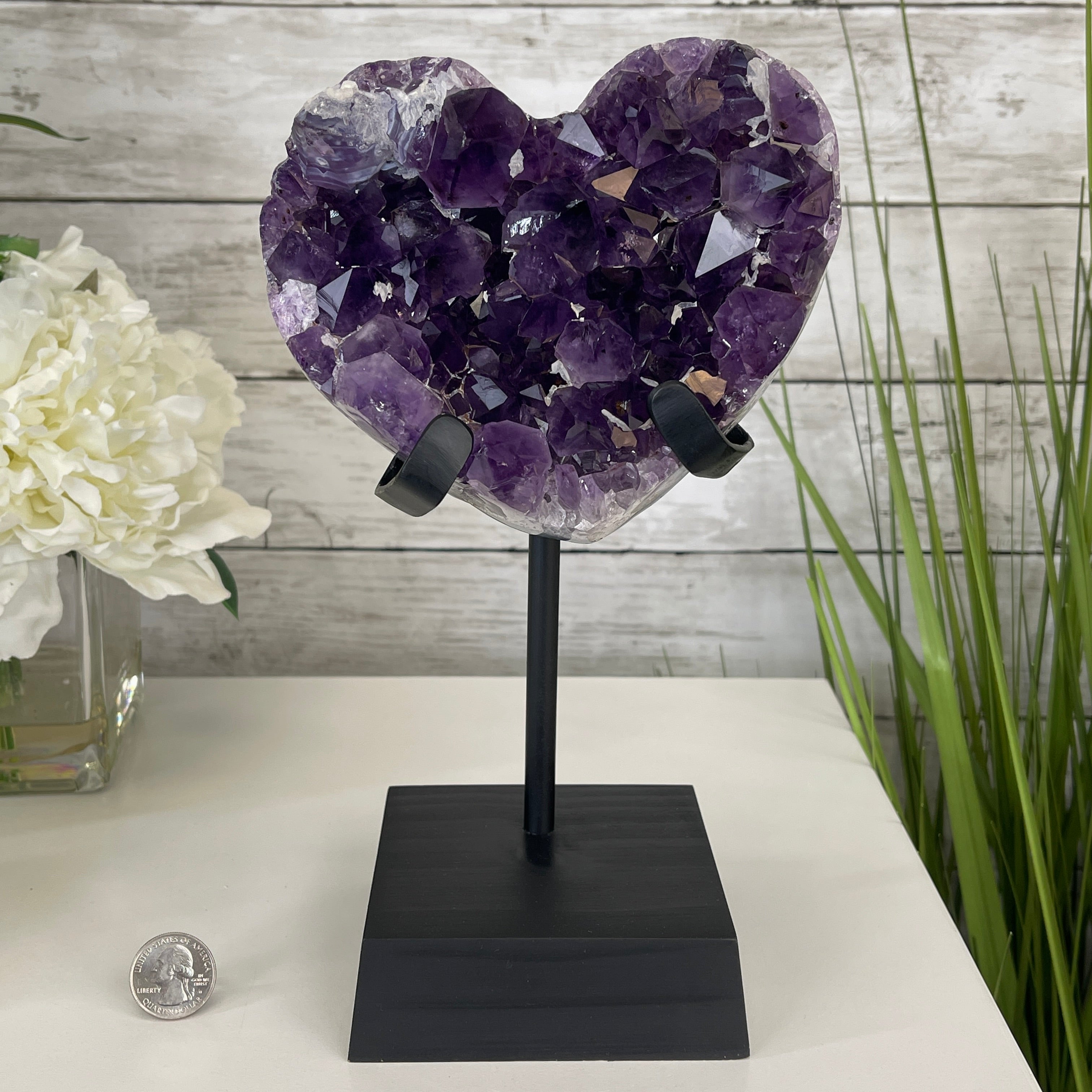 Heart-shaped amethyst geode positioned on a stand