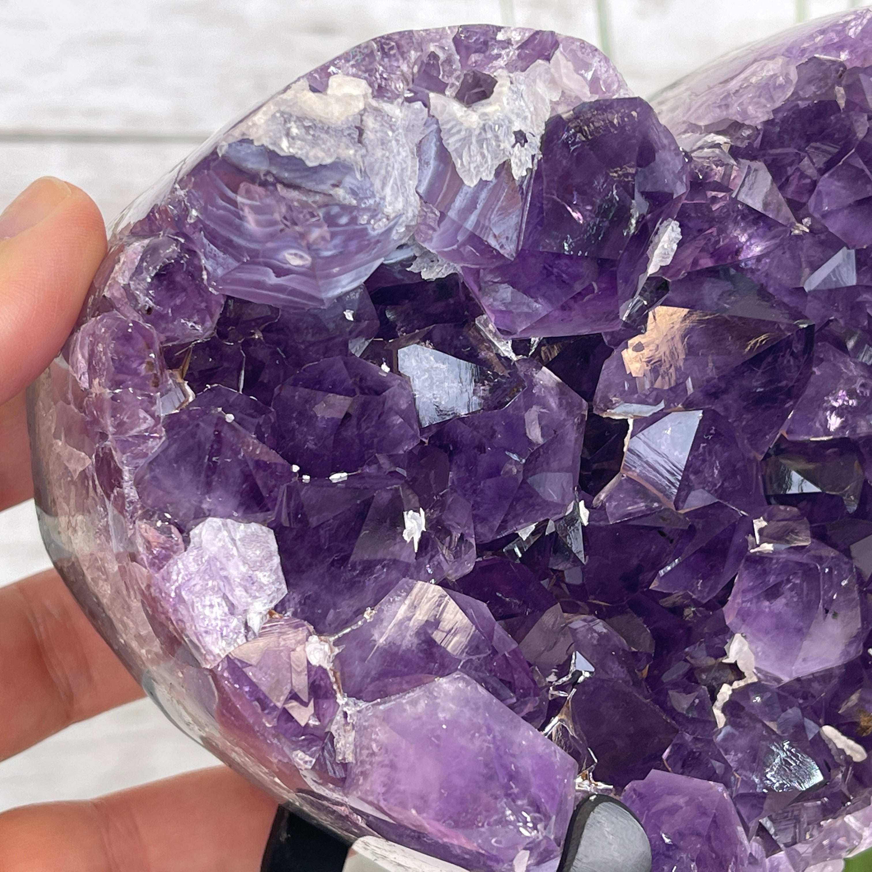 Individual holding a heart-shaped Amethyst Geode