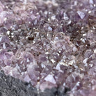 Close-up view of an Amethyst base with embedded crystals of a gemstone tree