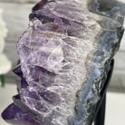 Piece of purple quartz amethyst on a black stand