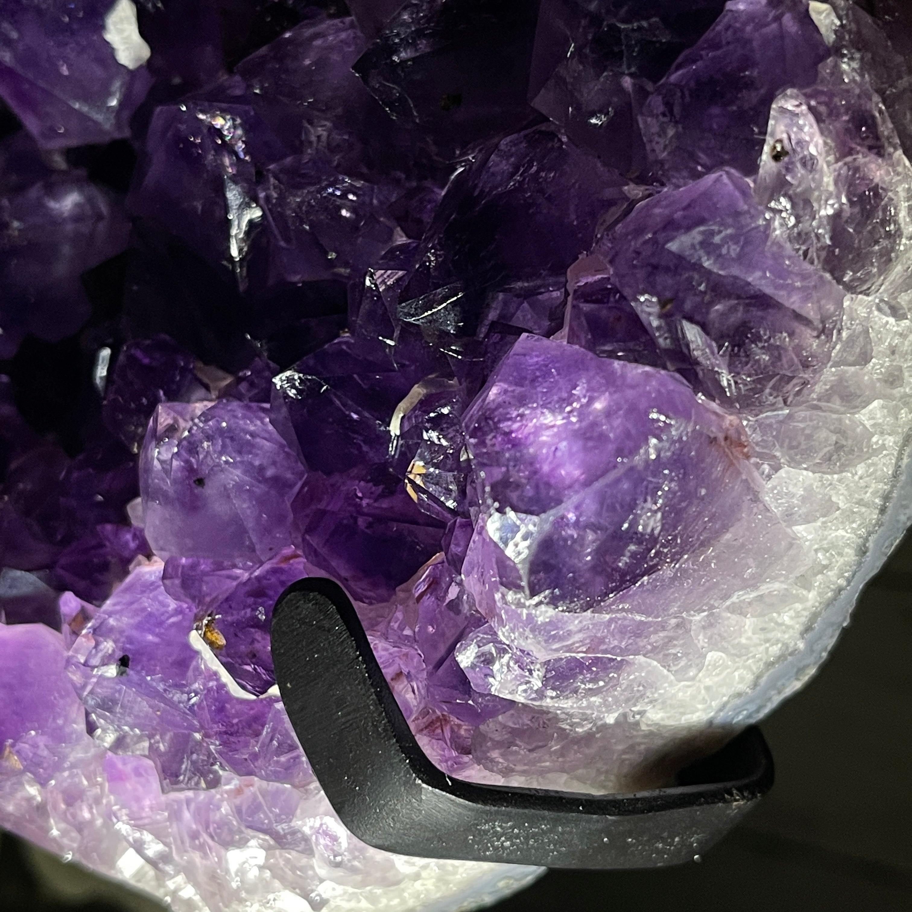 Amethyst heart geode resting on a black metal stand